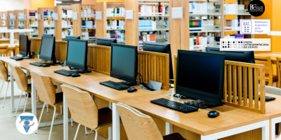 Foto de una biblioteca con libros y escritorios con computadoras